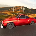 Red Vintage Car Driving On Road With Mountains Green Fields Wind Turbines And Sunset Sky