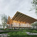 Modern Homestay Building With Wooden Roof Structure And Glass Windows Surrounded By Green Trees