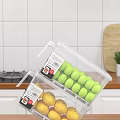 Transparent Plastic Storage Container With Green Balls And Yellow Fruits In Kitchen