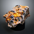 Natural Stone Mineral Specimen With Golden Crystal Inclusions And Black White Texture On Display Base