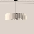 Scalloped Modern Chandelier Hanging Over White Wall With Decorative Crown Molding