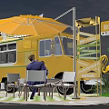 Yellow Food Truck With Outdoor Seating Umbrella Flamingo Decorations And 2023 Signage