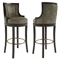 Elegant Bar Stools With Gray Upholstered Seats Dark Wooden Legs And Gold Footrest Rings
