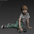 Young Boy With Red Hair Sitting On Light Floor Holding Toy Car In Gray T Shirt Green Pants