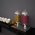 Beverage Dispensers with Yellow and Red Drinks on Black Countertop with White Bowls and Pineapple