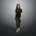 Woman in Black Top and Dark Pants with Green Shoes Standing Against Gray Background