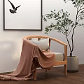 Accent Chair with Brown Throw Blanket Gray Cushion Potted Tree Bird Wall Art Wooden Floor