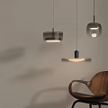 Modern Pendant Lights With Transparent Glass Shades And Black Metal Frames Near Wooden Chair