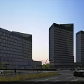 Modern Glass Facade Office Towers In Urban Area With Evening Light And Street View