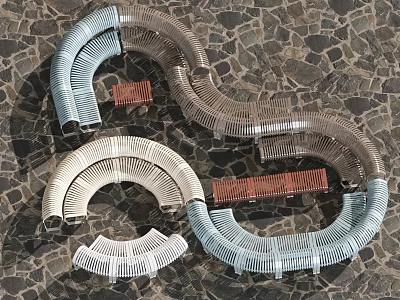 Curved Metal Woven Outdoor Chairs in Various Colors Arranged on Stone Ground 3d model