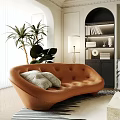 Brown Irregular Shaped Leather Sofa With White Cushions Green Plants Floor Lamp And Bookshelf