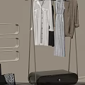 Modern Wheeled Clothes Rack With Hanging Shirts And Coats In Living Room With Sofa Plant