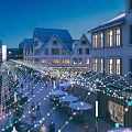 Vibrant Commercial Street At Night With Decorative Lights And Pedestrians