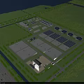 Aerial View of Industrial Factory Complex With Multiple Buildings Greenery Roads and Circular Ponds