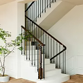 Staircase With Wooden Handrail Black Metal Balusters White Steps And Green Plant In Modern Interior
