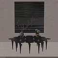 Modern Black Coffee Table With Geometric Legs And Decorative Items Against Abstract Wall Art