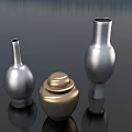 Ceramic Vessels Including Golden Lidded Jar And Silver Spherical Vases On Dark Reflective Surface