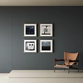 Abstract Paintings On Dark Gray Wall With Four Framed Artworks And Brown Chair