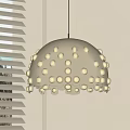 White Dome Pendant Light with Circular Holes Shining Through Light Colored Wall and Blinds