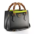 Black Pebbled Leather Handbag With Bamboo Handles Green Strap GG Logo And Structured Design
