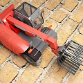 Red Industrial Loader With Mechanical Arm And Fork Attachment On Brick Floor 3d model