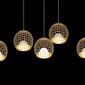 Spherical Woven Grid Pendant Lights with Warm Glow Hanging in Dark Setting