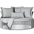 Round Outdoor Sofa with White Pillows Beige Blanket and Black Vertical Striped Frame