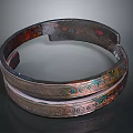 Carved Metallic Sculpture Circular Ring Shaped Design With Intricate Patterns And Colorful Accents
