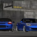 Two Blue Convertible Sports Cars Parked Near Concrete Structure And Tunnel Entrance