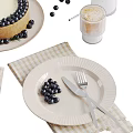 Delicious Blueberry Cheesecake Topped With Blueberries Served With Milk Bottle Glass Fork Knife And Plates