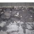 Damaged Asphalt Pavement With Visible Cracks And Potholes On Surface