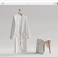 Soft White Long Robe Hanging On Wooden Hanger With Folded Towel On Stool
