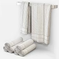 Brown Towels With Silver Trim Hanging On Rack And Rolled For Bathroom Decor