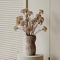 Dried Flowers Arrangement in Ribbed Vase on White Pedestal Against White Blinds