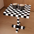 Black and White Checkered Side Table with Coffee Cups on Wooden Floor