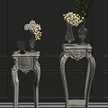 White Carved Side Tables With Glass Vases And Flowers On Gray Wall Backdrop