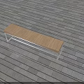 Public Bench with Wooden Seat and Metal Frame on Stone Pavement