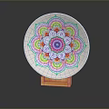 Intricate White Ceramic Plate Sculpture with Colorful Mandala Pattern on Orange Base