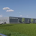 Modern Industrial Factory Building With Gray Exterior Green Lawn Trees Blue Sky And White Clouds