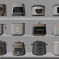 Various Design Electric Rice Cookers And Pressure Cookers Displayed On Shelves