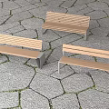 Wooden Outdoor Benches With Metal Frames On Stone Pavement And Grass