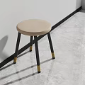 Beige Round Stool With Gray Legs And Gold Feet In Modern Interior