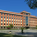 Red Brick Office Building With Multiple Windows Front Plaza Green Plants And Blue Sky