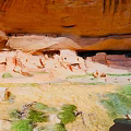 Stunning Red Rock Landscape With Ancient Cliff Dwellings And Lush Green Vegetation