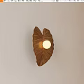 Modern Leaf Shaped Brown Wall Lamp With Round Bulb On Light Wall