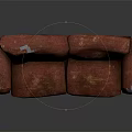 Worn Red Two-Seater Sofa with White Tape Patches on Dark Background
