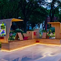 Landscape Seating With Wooden Design Illuminated In Outdoor Park Surrounded By Greenery