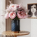 Modern Decorative Arrangement With Black Vase Pink Peonies And Framed Painting On Round Table