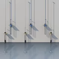 Three Modern Chandeliers With Blue Accents And Glass Tubes Hanging In Interior Space
