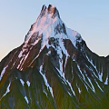 Scenic Mountain Terrain With Snow Capped Peaks And Sunlit Green Slopes